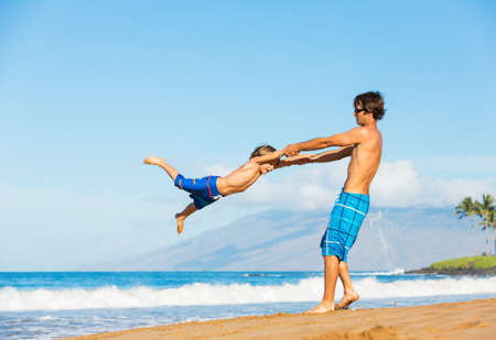 Happy father and daughter playing together at the beach carefree happy fun smiling lifestyleの写真素材