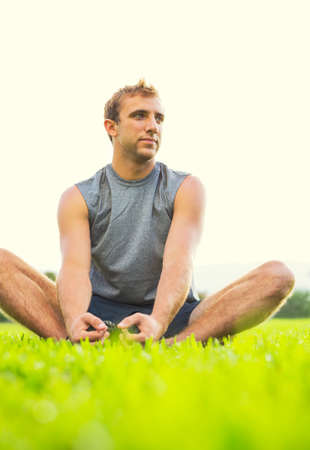 Attractive fit young man stretching before exerciseの写真素材