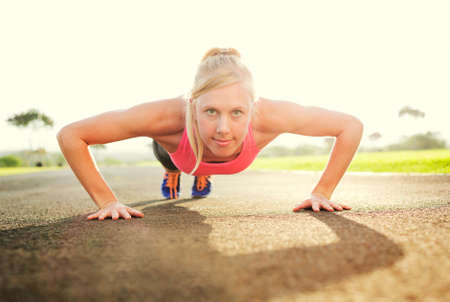 Attractive young woman doing push up