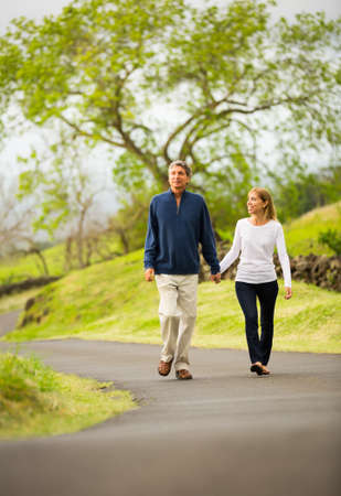 Mature middle age couple in love walking in countrysideの写真素材