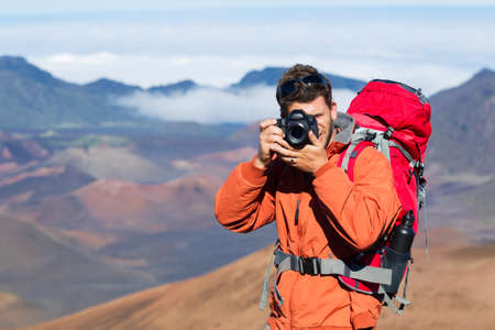 Photographer taking pictures outdoors on hiking trip. Outdoor nature photography.の写真素材
