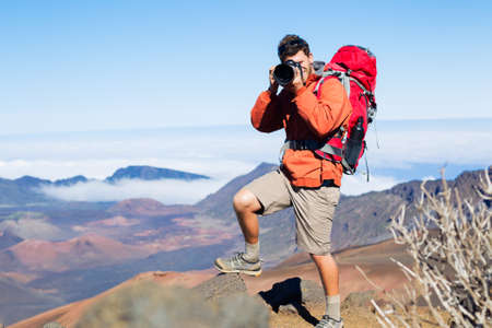 Photographer taking pictures outdoors on hiking trip. Outdoor nature photography.の写真素材