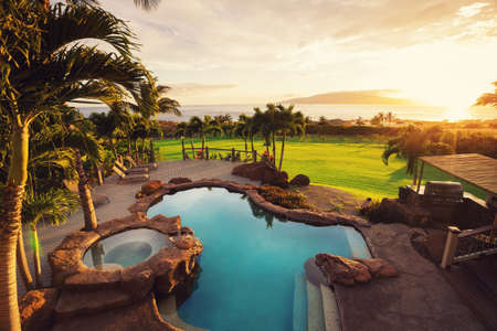 Luxury home with swimming pool at sunset Luxury home with swimming pool at sunset