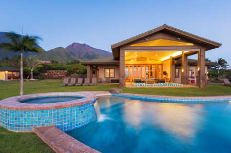 Luxury home with swimming pool at sunsetの写真素材