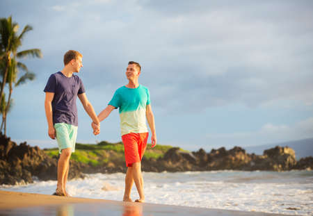 Happy gay couple on the beachの写真素材