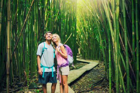 Couple having fun together outdoors on hike through amazing bamboo forest trail.の写真素材