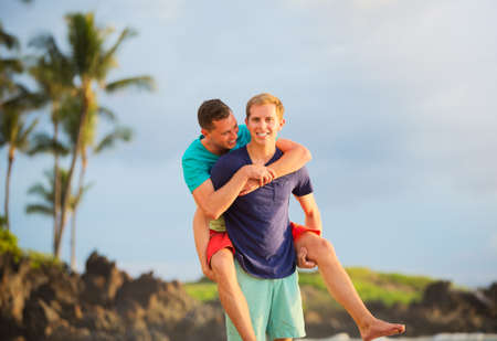 Happy gay couple on the beachの写真素材