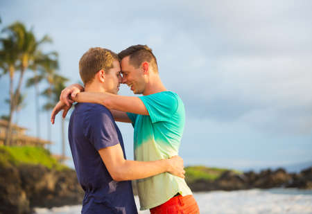Happy gay couple on the beachの写真素材