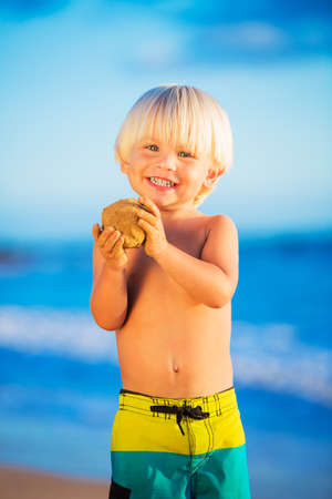 Happy young boy playing at the beachの写真素材