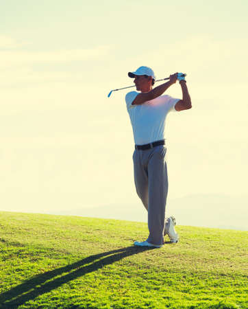 Man Playing Golf on Course Early Morning at Sunriseの写真素材