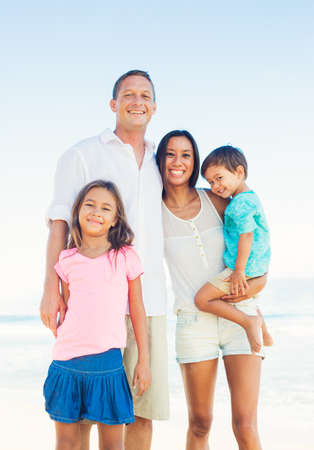 Happy Portrait of Mixed Race Family on the Beach