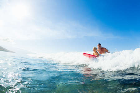 Father and Son Surfing Together. Riding Wave on Surfboard Tandem. Fatherhood, Family Fun Outdoor...