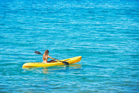 Woman Kayaking in the Oceanの写真素材
