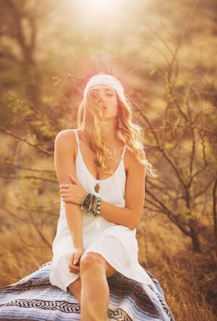 Fashion Lifestyle, Portrait of Beautiful Young Woman Backlit at Sunset Outdoors. Soft warm sunny colors.の写真素材