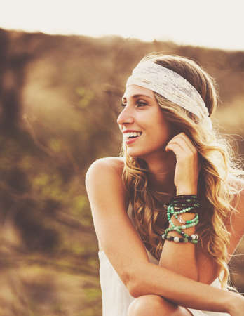 Fashion Lifestyle, Portrait of Beautiful Young Woman Backlit at Sunset Outdoors. Soft warm colors.の写真素材