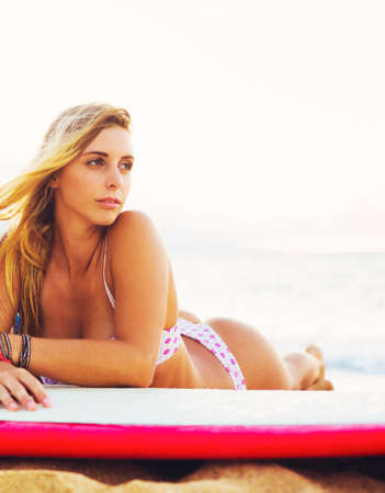 Beautiful Blonde Surfer Girl on the Beach at Sunset