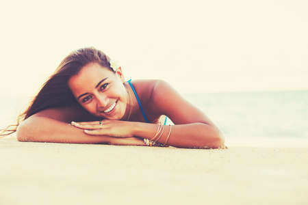 Summer Lifestyle, Beautiful Happy Carefree Young Woman Relaxing on the Beach at Sunsetの写真素材