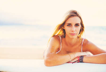 Beautiful Blonde Surfer Girl on the Beach at Sunset