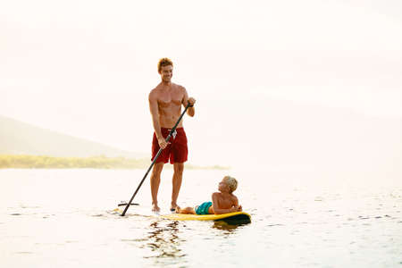 Father and Son Stand Up Paddling at Sunriseの写真素材