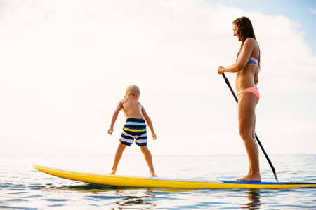 Mother and Son Stand Up Paddling Together Having Fun in the Oceanの写真素材