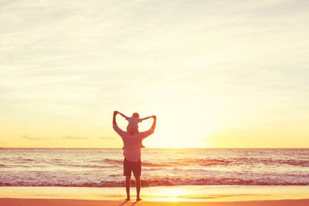 Father and Son Playing on the Beach at Sunset, Having Quality Family TIme Together.の写真素材