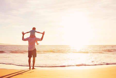 Father and Son Playing on the Beach at Sunsetの写真素材