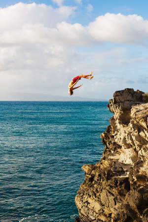 Cliff Jumping into the Ocean at Sunset, Summer Fun Lifestyleの写真素材