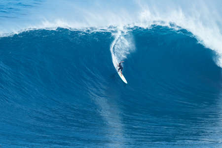 MAUI, HI - JANUARY 16 2016: Professional surfer Joao Marco Maffini rides a giant wave at the legendary big wave surf break known as "Jaws" on one the largest swells of the year.のeditorial素材