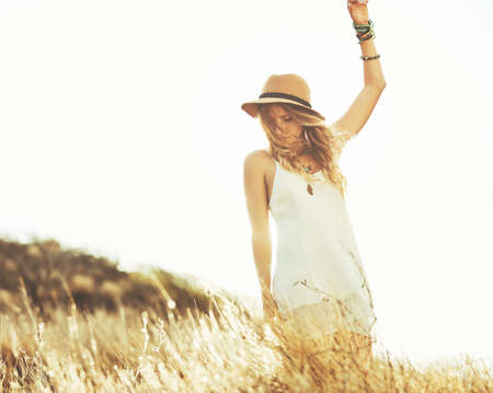 Fashion Lifestyle. Fashion Portrait of Beautiful Young Woman Outdoors. Soft warm vintage color tone....
