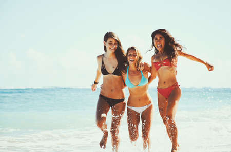Beautiful young women having fun at the beachの写真素材