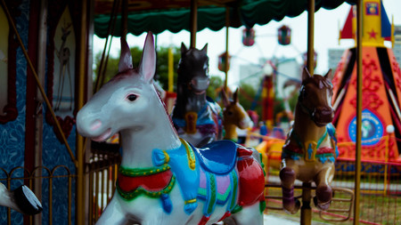 Outdoor colorful vintage flying horse carousel in the parkの写真素材