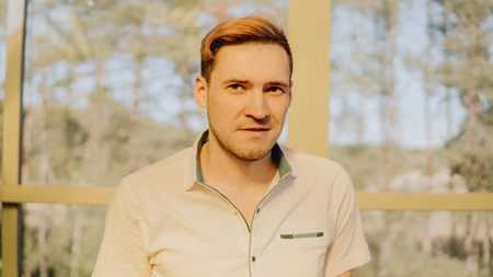 Portrait of a handsome man. Happy young man standing on a black backgroundの写真素材