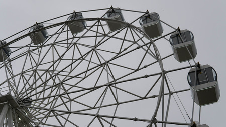 Ferris wheel on blue colorful sky background. Amusement park. Summer holidays and vacations.の写真素材