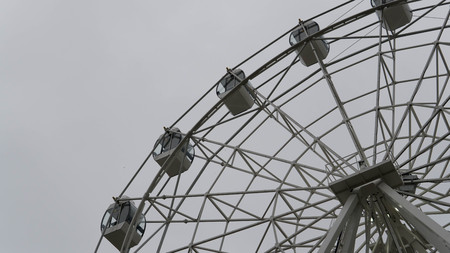Ferris wheel on blue colorful sky background. Amusement park. Summer holidays and vacations.の写真素材