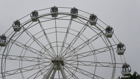 Ferris wheel on blue colorful sky background. Amusement park. Summer holidays and vacations.の写真素材