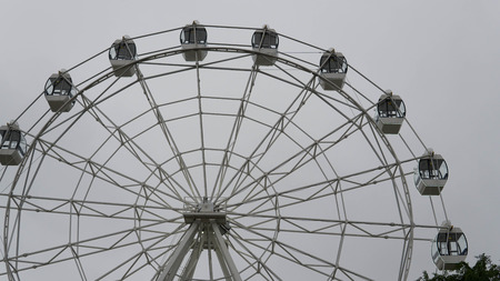 Ferris wheel on blue colorful sky background. Amusement park. Summer holidays and vacations.の写真素材