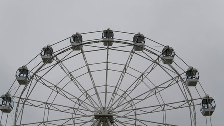 Ferris wheel on blue colorful sky background. Amusement park. Summer holidays and vacations.の写真素材