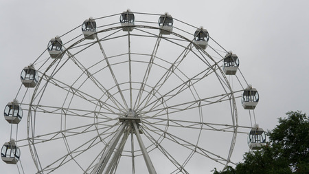 Ferris wheel on blue colorful sky background. Amusement park. Summer holidays and vacations.の写真素材