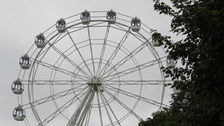 Ferris wheel on blue colorful sky background. Amusement park. Summer holidays and vacations.の写真素材