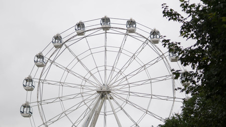 Ferris wheel on blue colorful sky background. Amusement park. Summer holidays and vacations.の写真素材