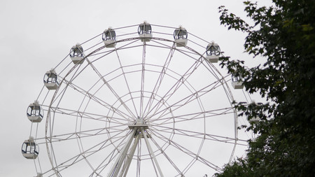 Ferris wheel on blue colorful sky background. Amusement park. Summer holidays and vacations.の写真素材