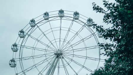 Ferris wheel on blue colorful sky background. Amusement park. Summer holidays and vacations.の写真素材