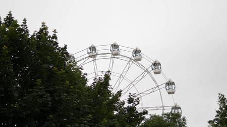 Ferris wheel on blue colorful sky background. Amusement park. Summer holidays and vacations.の写真素材