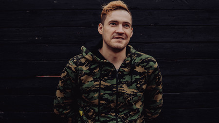 Guy camo, a man in a hoodie on a black wooden background. Soldiers at the wallの写真素材
