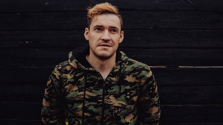 Guy camo, a man in a hoodie on a black wooden background. Soldiers at the wallの写真素材
