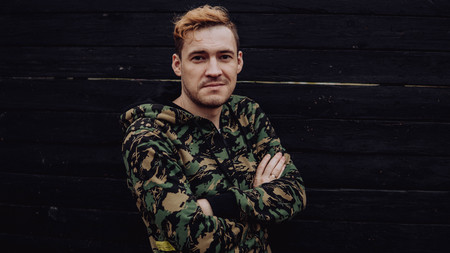 Guy camo, a man in a hoodie on a black wooden background. Soldiers at the wallの写真素材