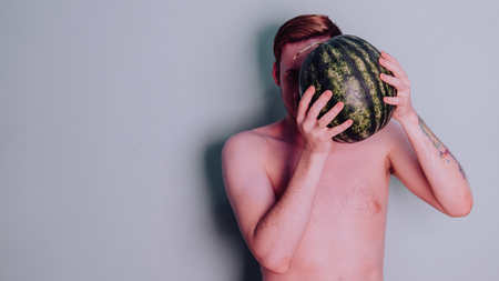 A man and a watermelon / Boy in classic suit with a watermelonの写真素材