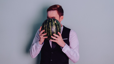 A man and a watermelon / Boy in classic suit with a watermelonの写真素材