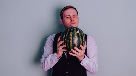 A man and a watermelon / Boy in classic suit with a watermelonの写真素材