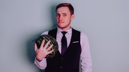 A man and a watermelon / Boy in classic suit with a watermelonの写真素材